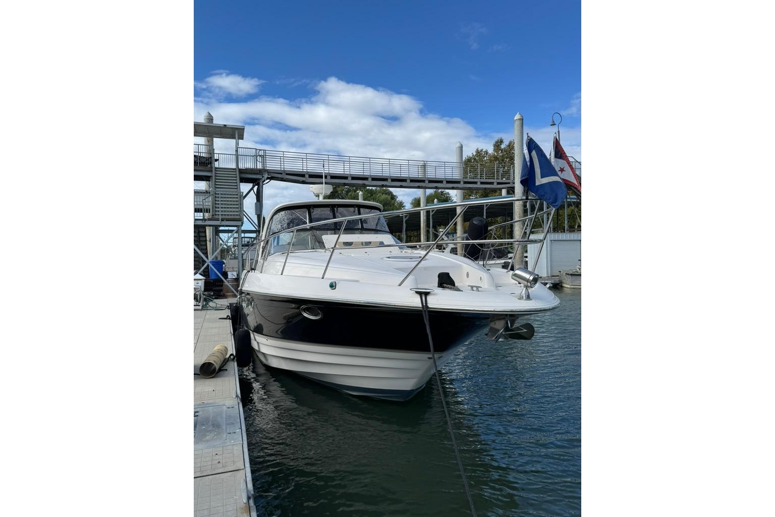 2006 Regal Commodore 4460 yacht docked at marina under blue sky.