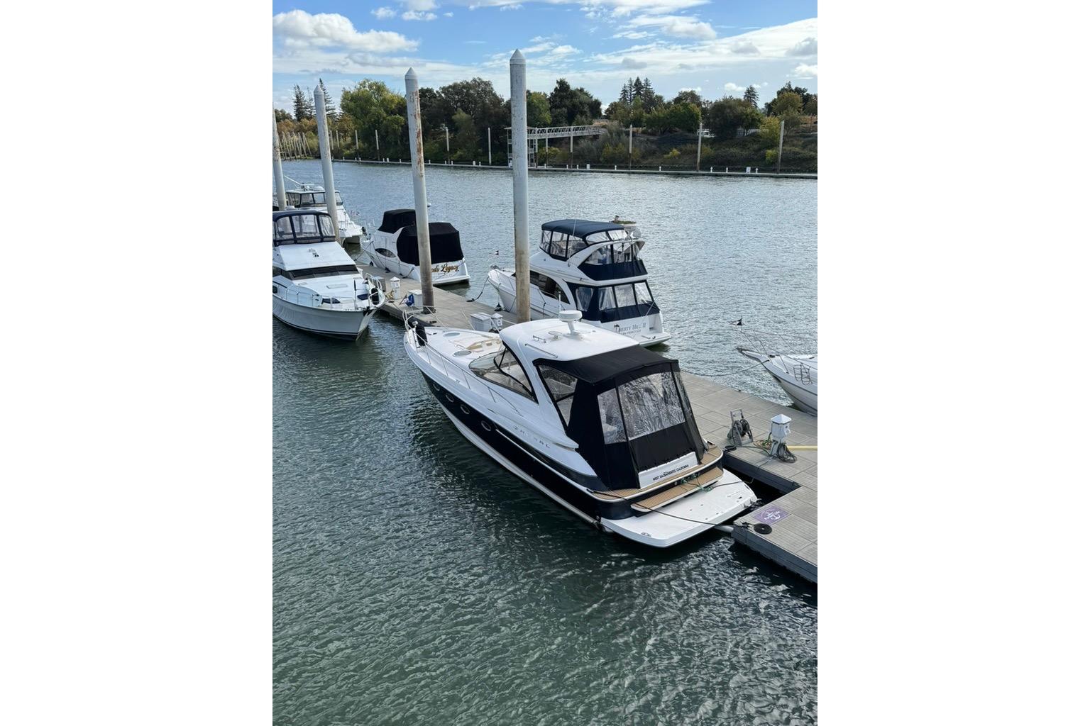 2006 Regal Commodore 4460 yacht docked at a marina with other boats.