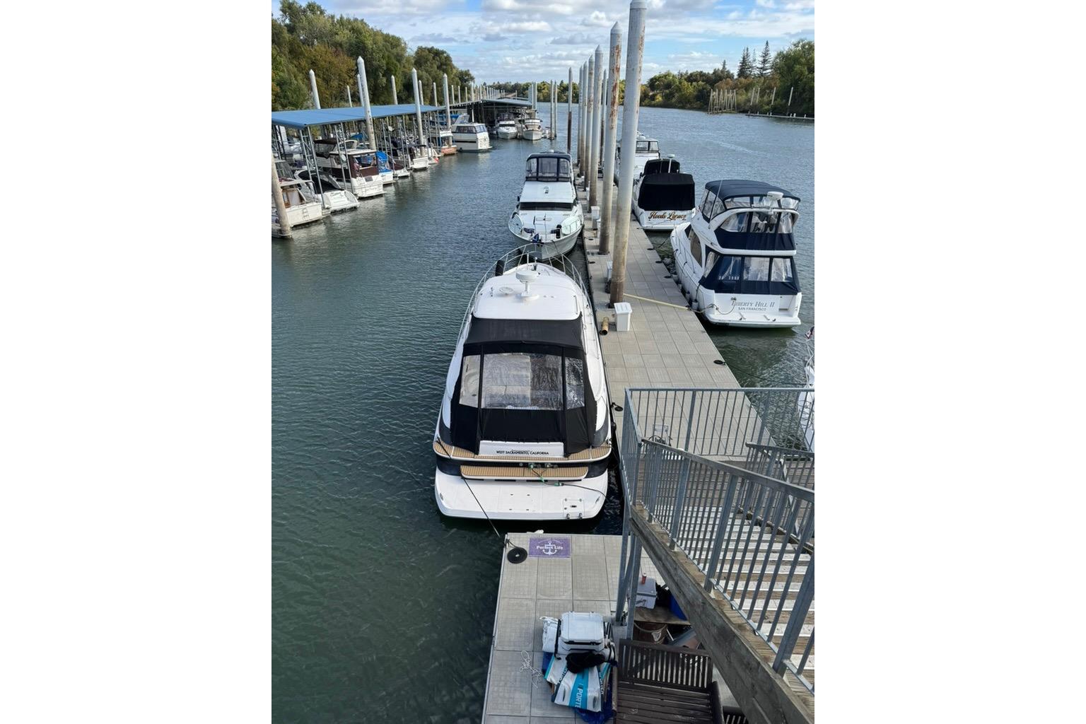 2006 Regal Commodore 4460 yacht docked at marina with other boats.