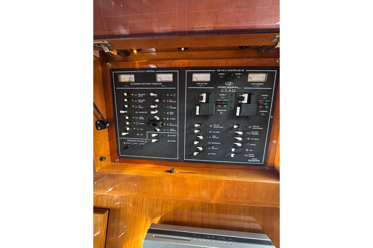 Control panel of 2006 Regal Commodore 4460 boat, featuring various switches and gauges.