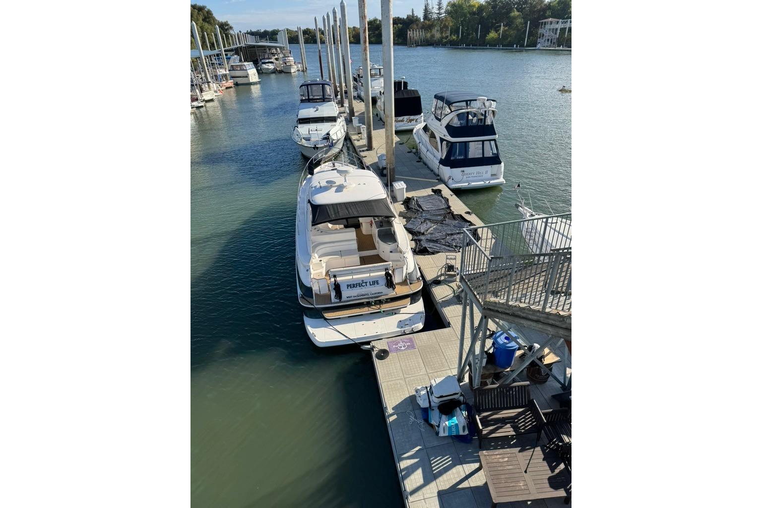 2006 Regal Commodore 4460 yacht docked at marina, surrounded by other boats.