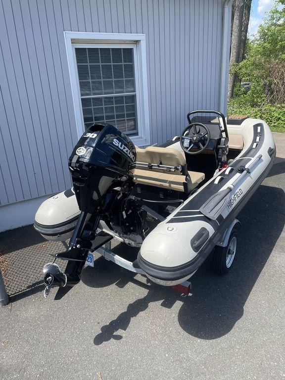 2023 Highfield Classic 380 GT Limited inflatable boat with Suzuki outboard motor on trailer.