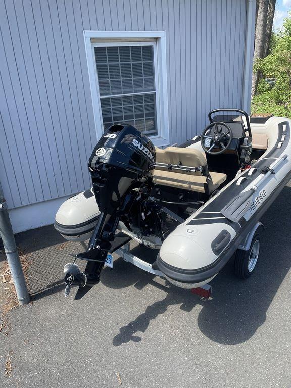 2023 Highfield Classic 380 GT Limited inflatable boat with Suzuki outboard motor, parked on trailer.