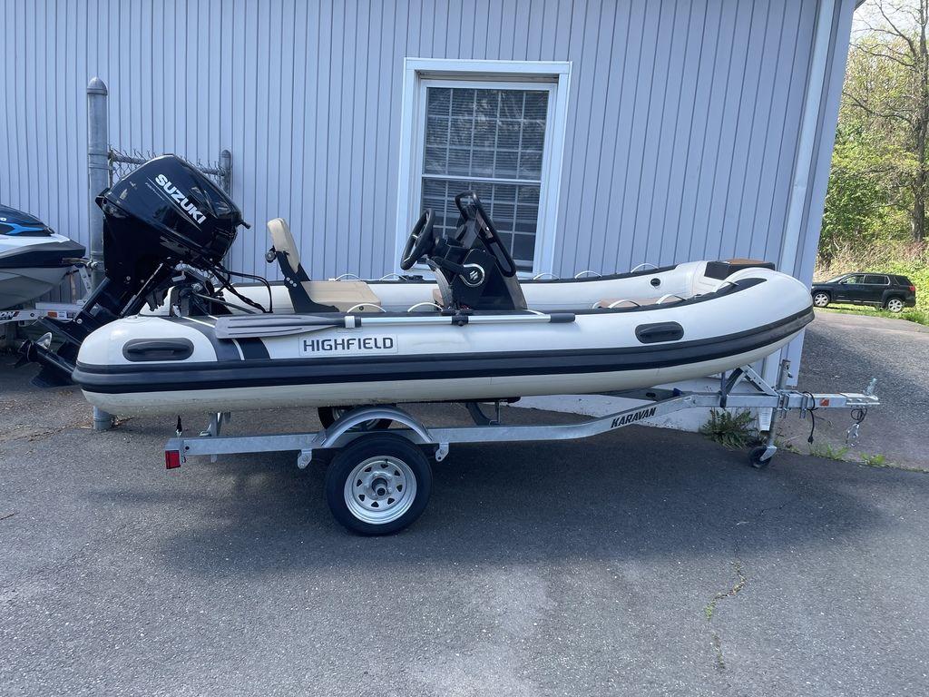 2023 Highfield Classic 380 GT Limited boat on trailer, parked outside a building.