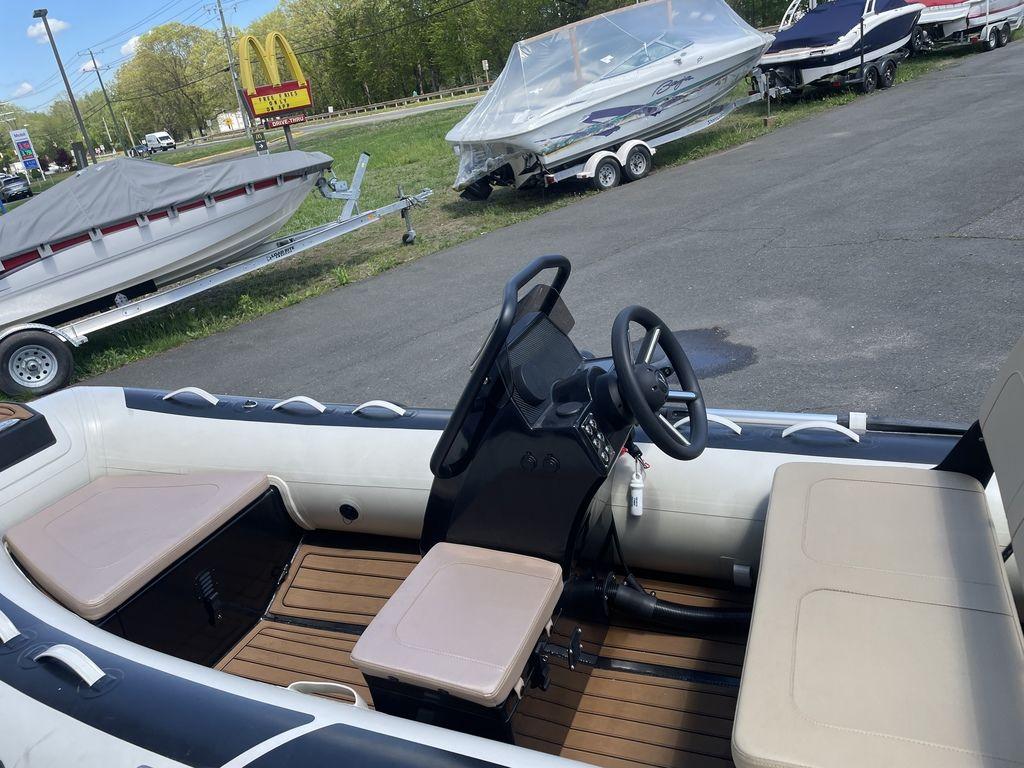 2023 Highfield Classic 380 GT Limited boat interior with steering wheel and seating.