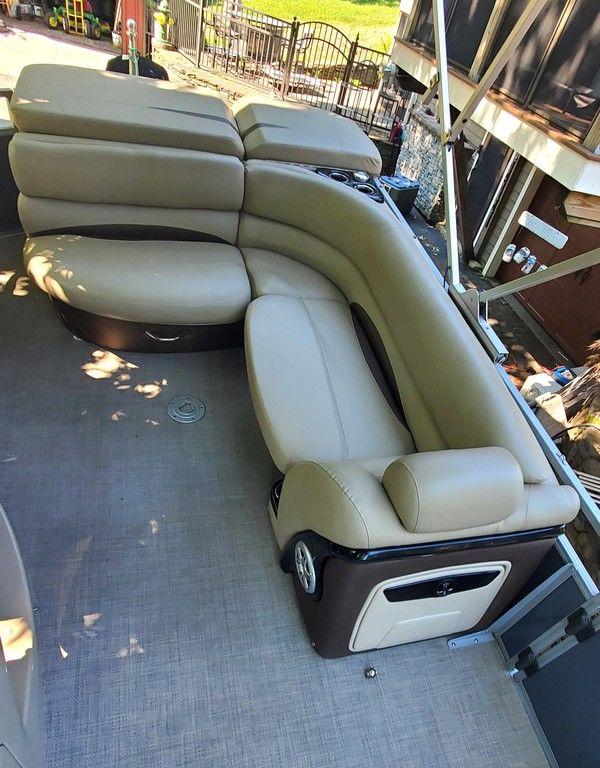 2017 Regency 220 DL3 boat with beige seating and spacious deck area.