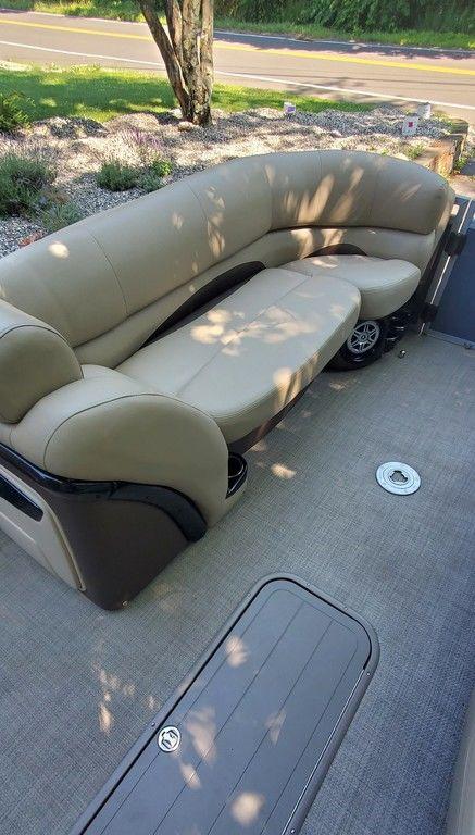 2017 Regency 220 DL3 boat interior with beige seating and carpeted floor.