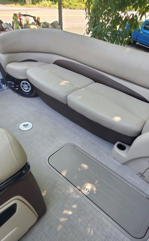 2017 Regency 220 DL3 boat interior with beige seating and carpeted floor.