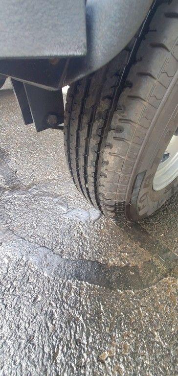 Close-up of a 2017 Regency 220 DL3 tire on wet pavement.
