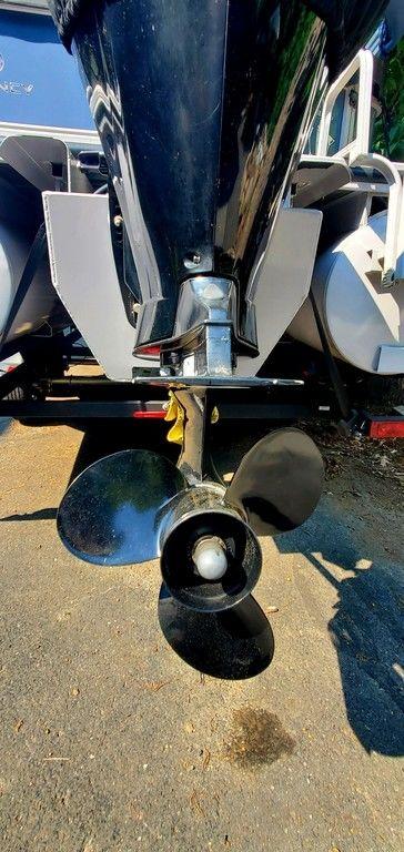 2017 Regency 220 DL3 boat propeller and motor close-up in sunlight.