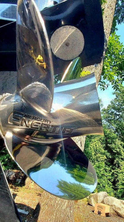Close-up of a shiny Mercury engine propeller on a 2017 Regency 220 DL3 boat.
