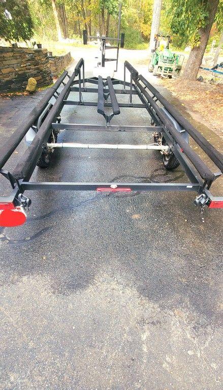2017 Regency 220 DL3 boat trailer on paved driveway, surrounded by trees.