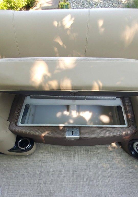 2017 Regency 220 DL3 boat seat with open storage compartment, beige upholstery.