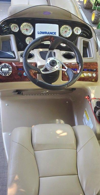2017 Regency 220 DL3 boat dashboard with steering wheel and Lowrance display.