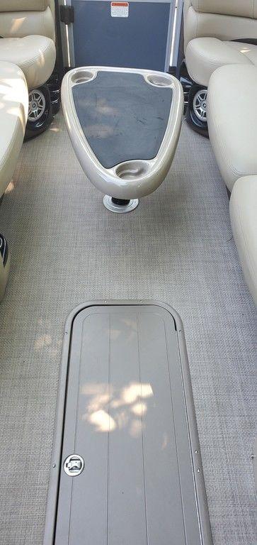 2017 Regency 220 DL3 boat interior with beige seating and central table.