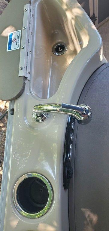 2017 Regency 220 DL3 boat sink with faucet and cup holder.