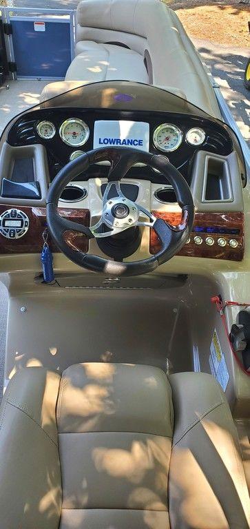 2017 Regency 220 DL3 boat dashboard with steering wheel and gauges.
