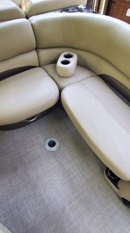 2017 Regency 220 DL3 boat interior with beige seating and cup holders.