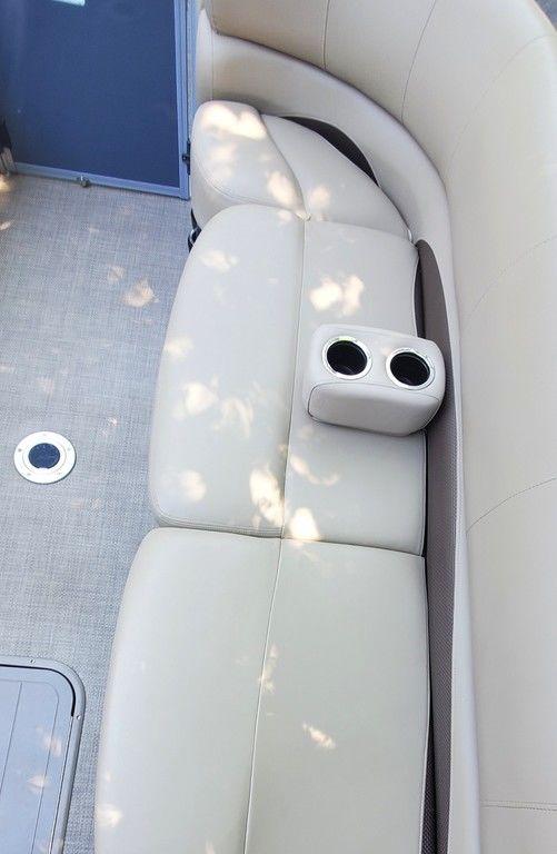2017 Regency 220 DL3 boat interior with beige seating and built-in cup holders.