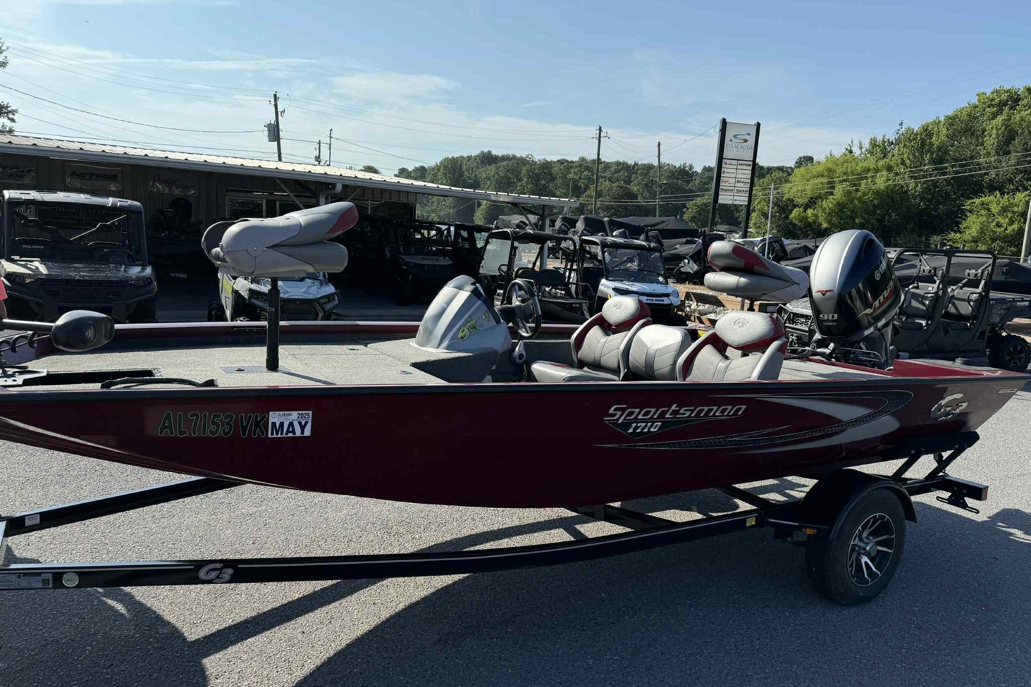 2020 G3 Sportsman 1710 boat with trailer, parked outdoors, featuring a red exterior.