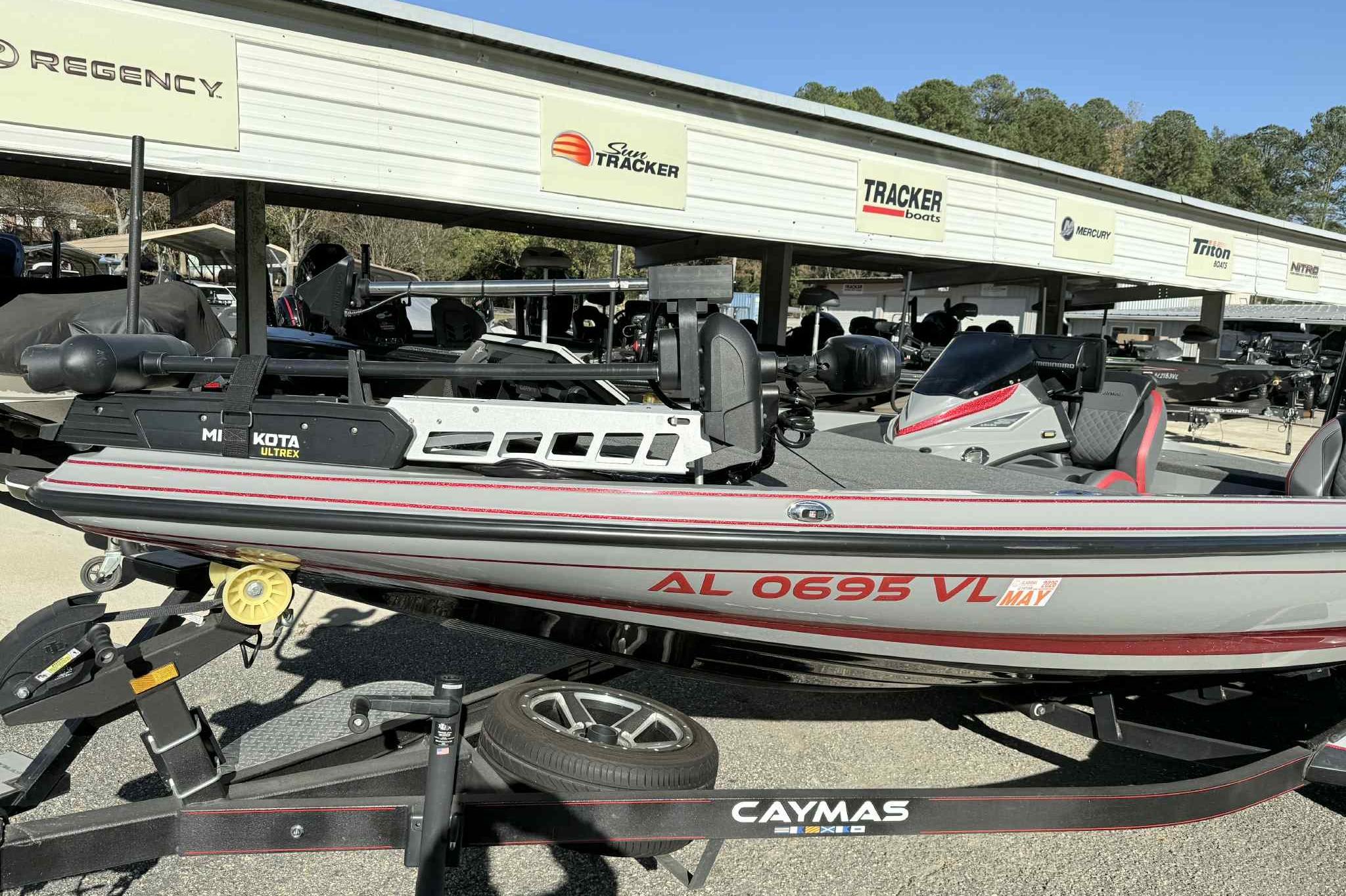 2022 Caymas CX20PRO boat on trailer, featuring Minn Kota Ultrex motor, parked at dealership.