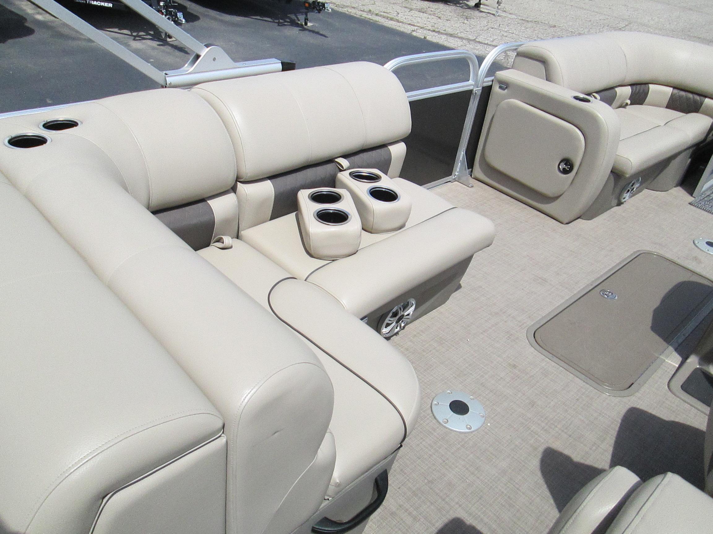 2023 Sun Tracker PARTY BARGE 22RF XP3 interior with beige seating and cup holders.