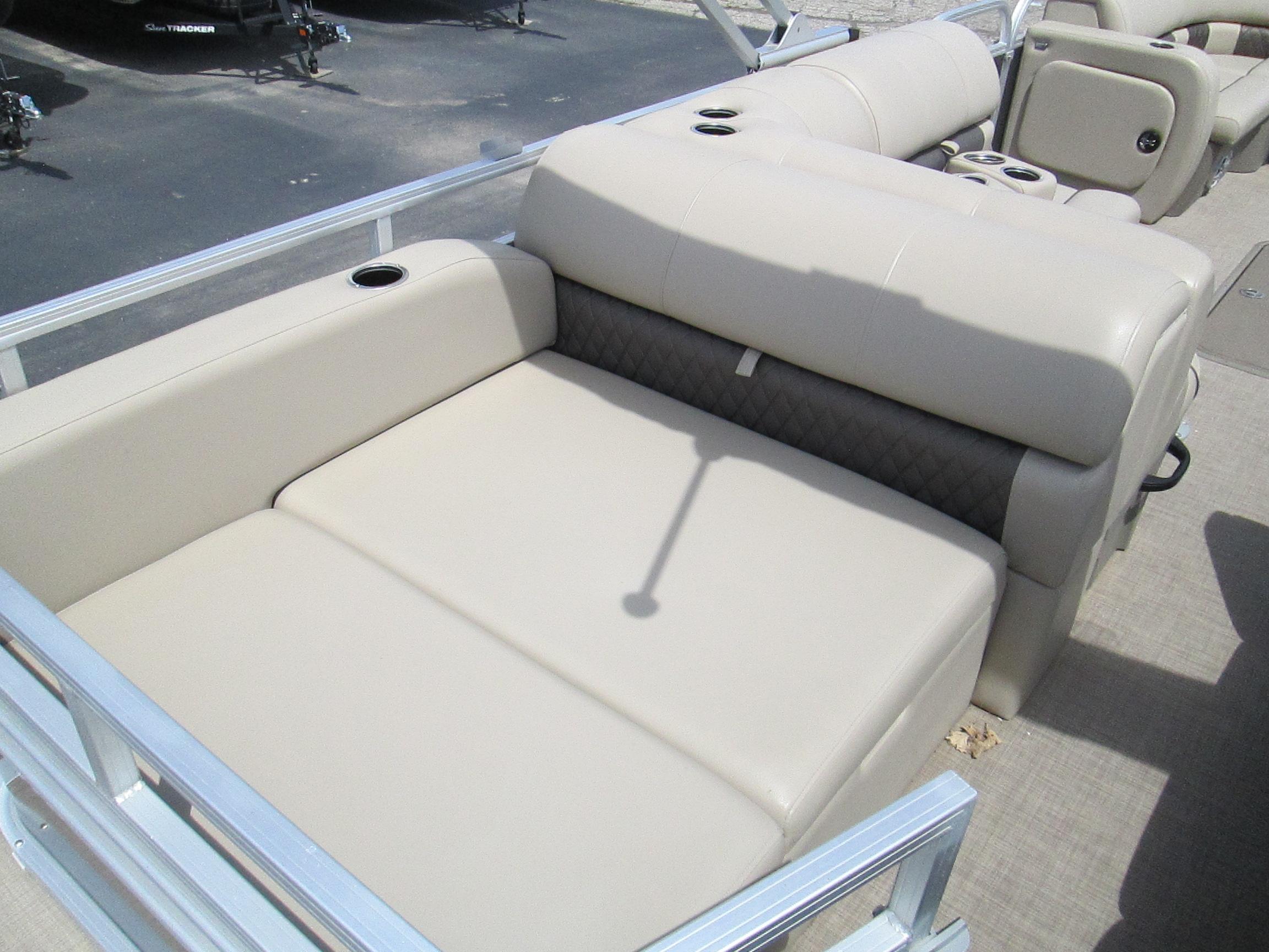 2023 Sun Tracker PARTY BARGE 22RF XP3 pontoon boat with beige seating and cup holders.
