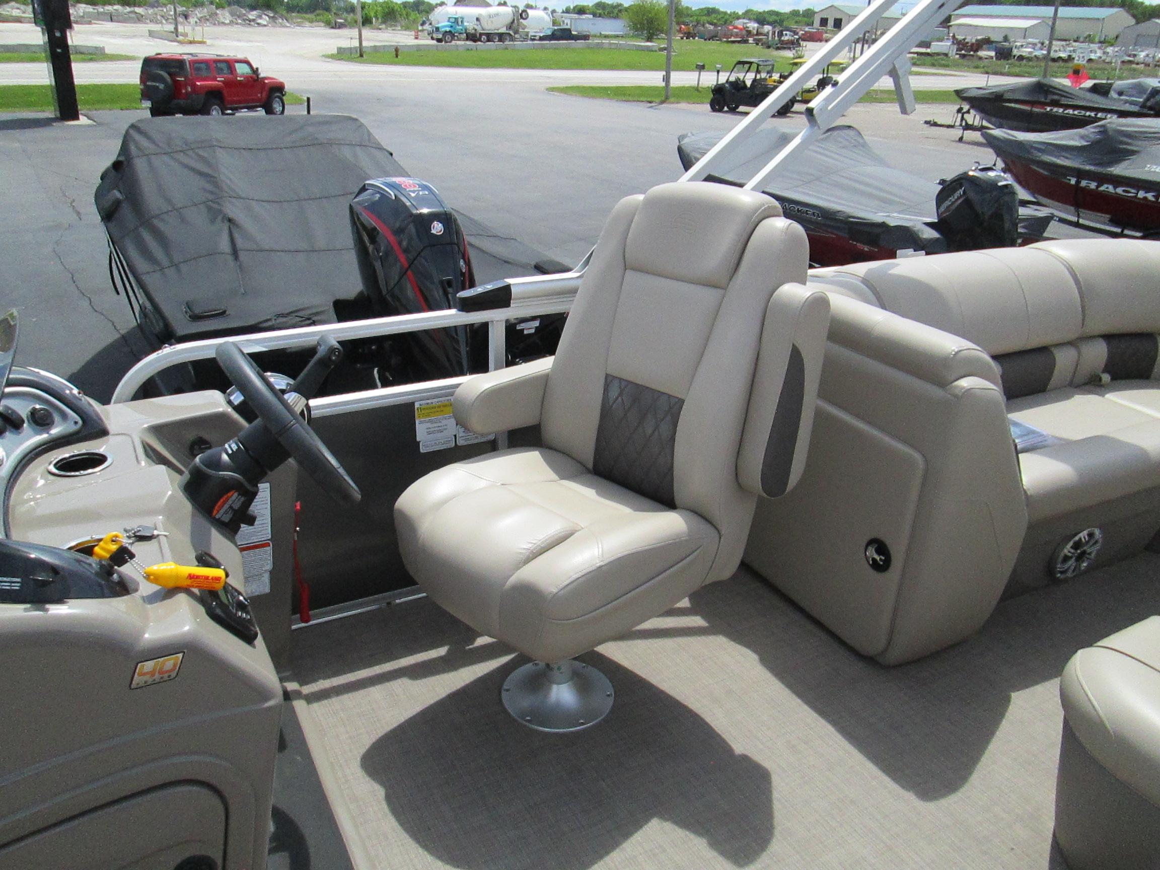 2023 Sun Tracker PARTY BARGE 22RF XP3 pontoon boat with beige captain's chair and steering console.