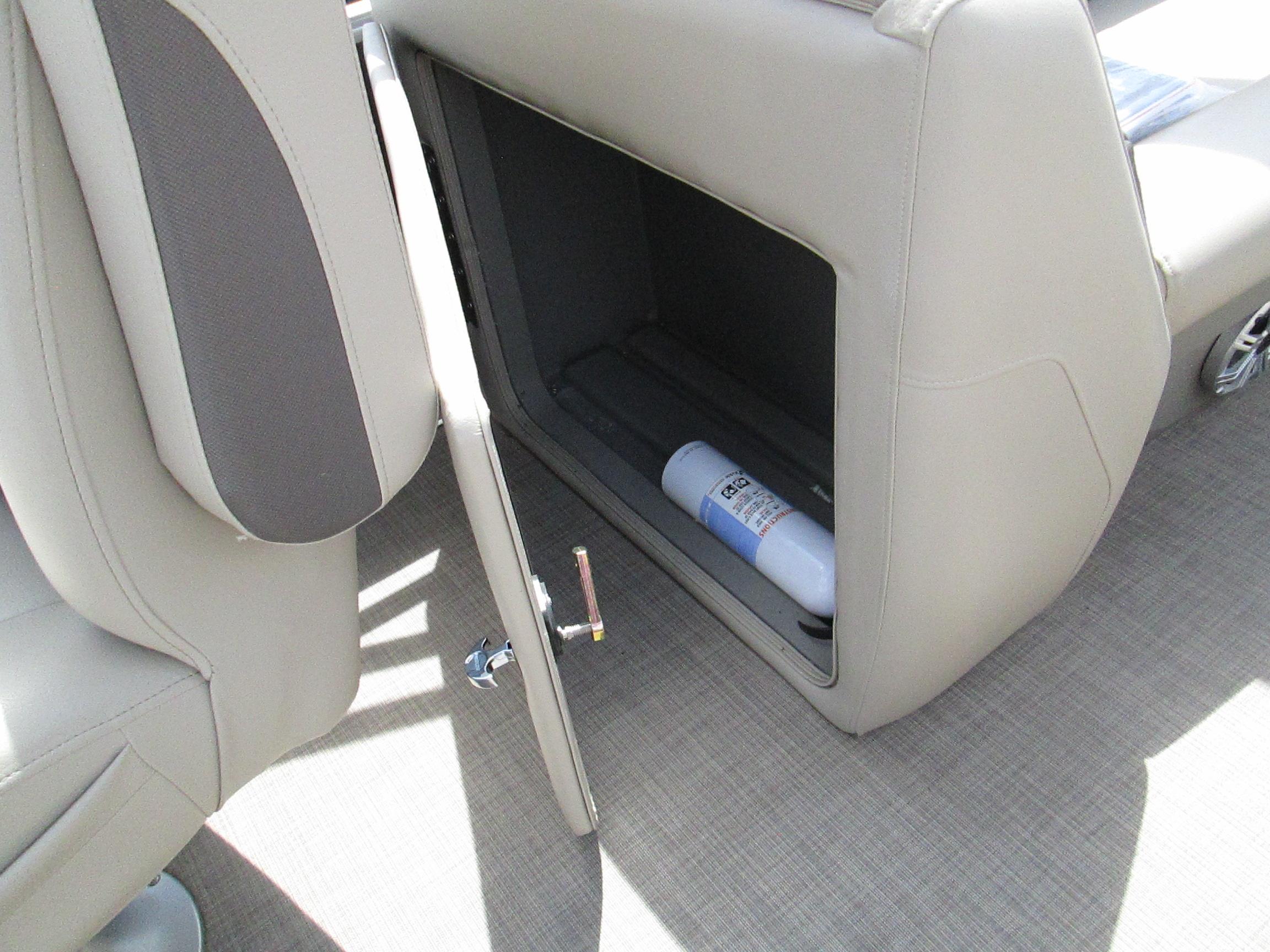 2023 Sun Tracker PARTY BARGE 22RF XP3 storage compartment with open door and visible fire extinguisher.