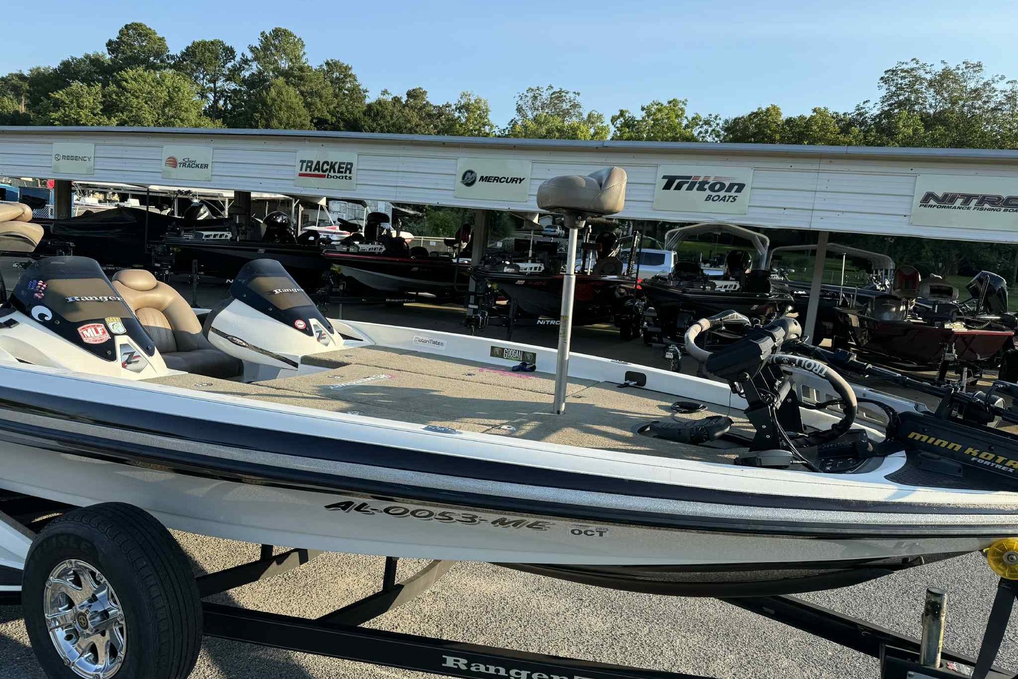 2012 Ranger Z521 Comanche boat on trailer, parked at dealership with other boats.