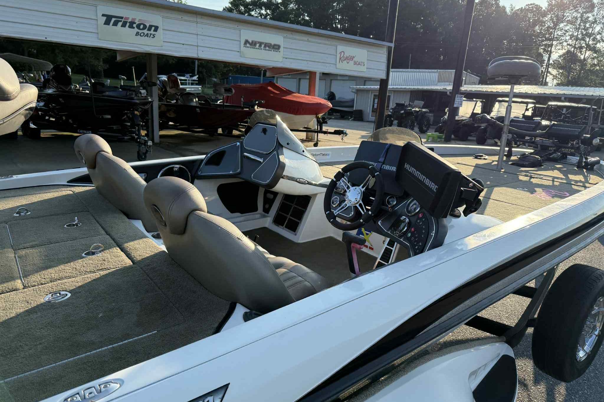 2012 Ranger Z521 Comanche boat interior with steering console and seats at a dealership.