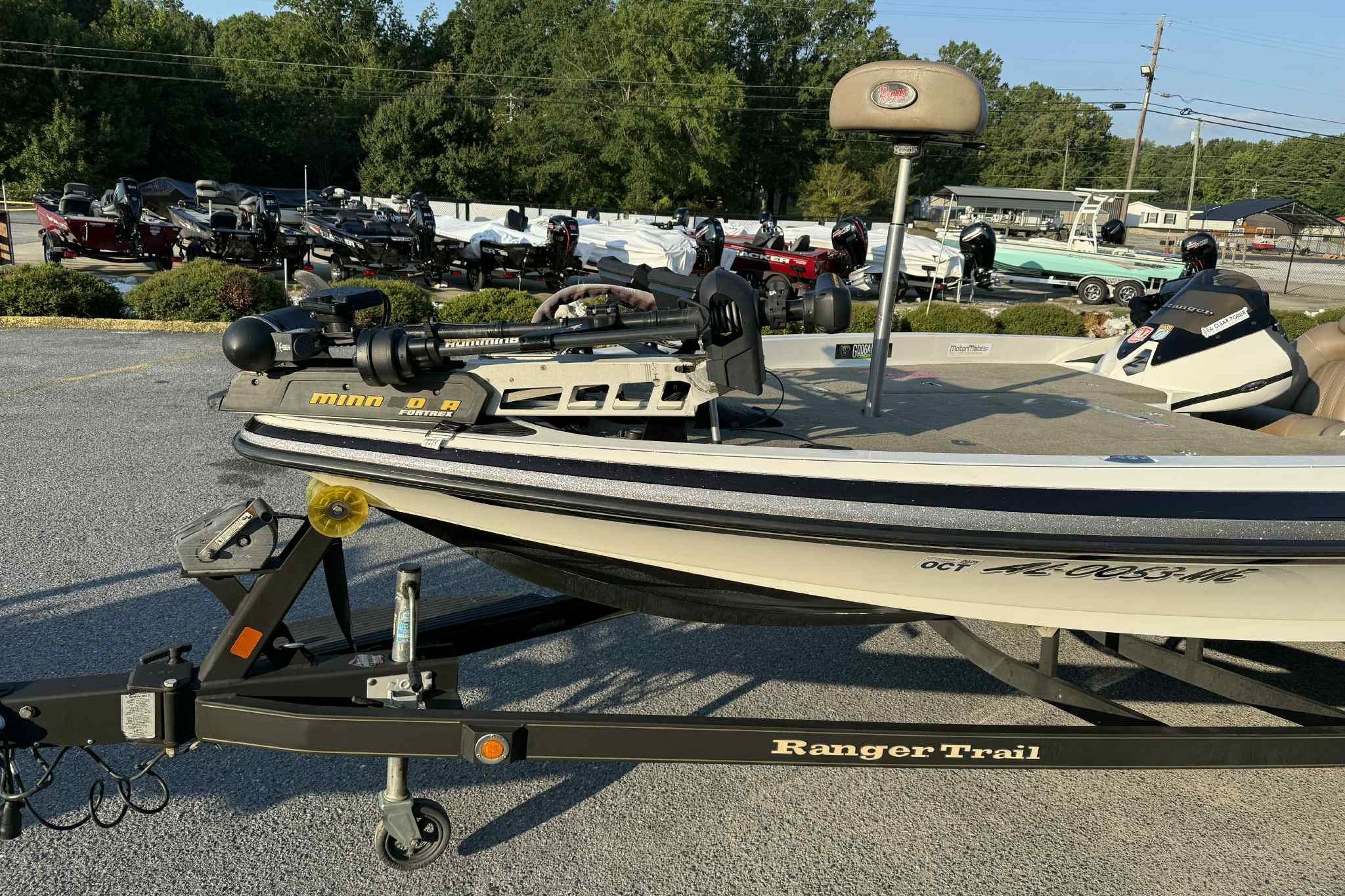 2012 Ranger Z521 Comanche boat on trailer in outdoor lot with other boats.