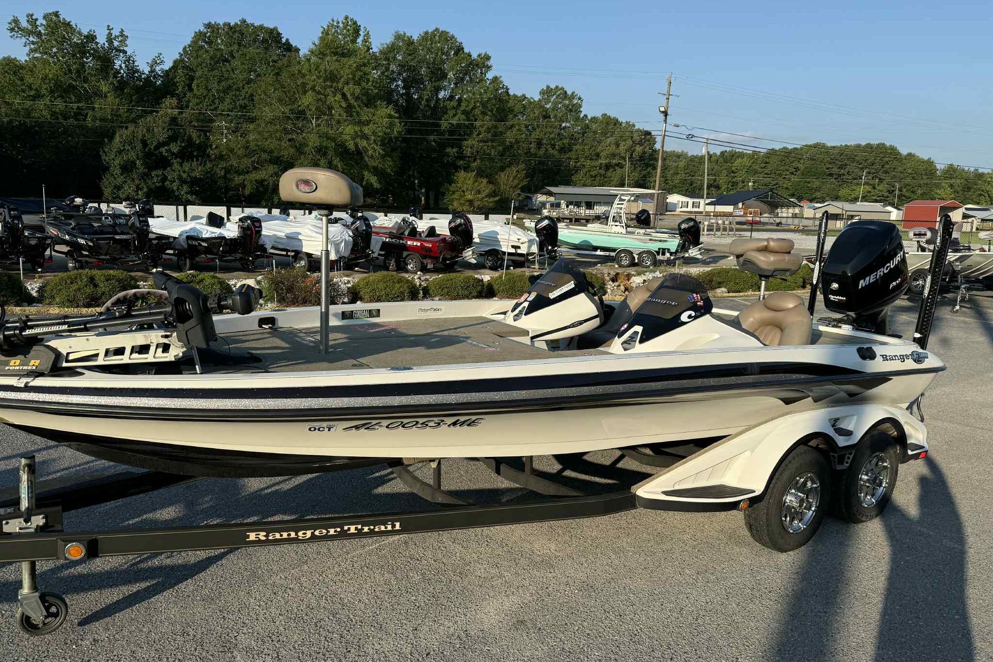 2012 Ranger Z521 Comanche boat on trailer, parked outdoors with trees in background.