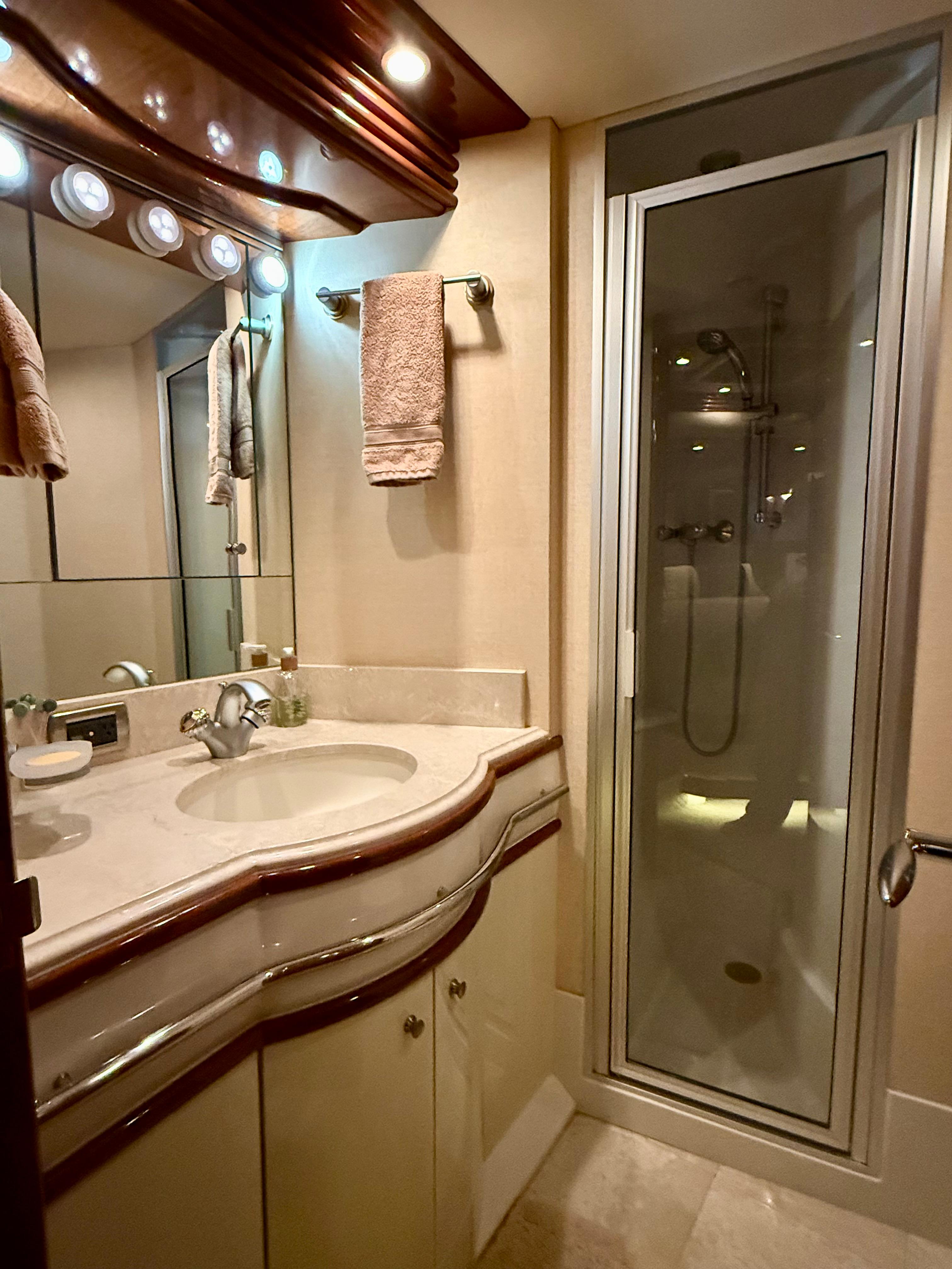 Marquis-65 2005-Tenacity FL-US-Luxurious bathroom in 2005 Marquis 65 yacht with elegant fixtures and glass shower.-9656261 | Thumbnail