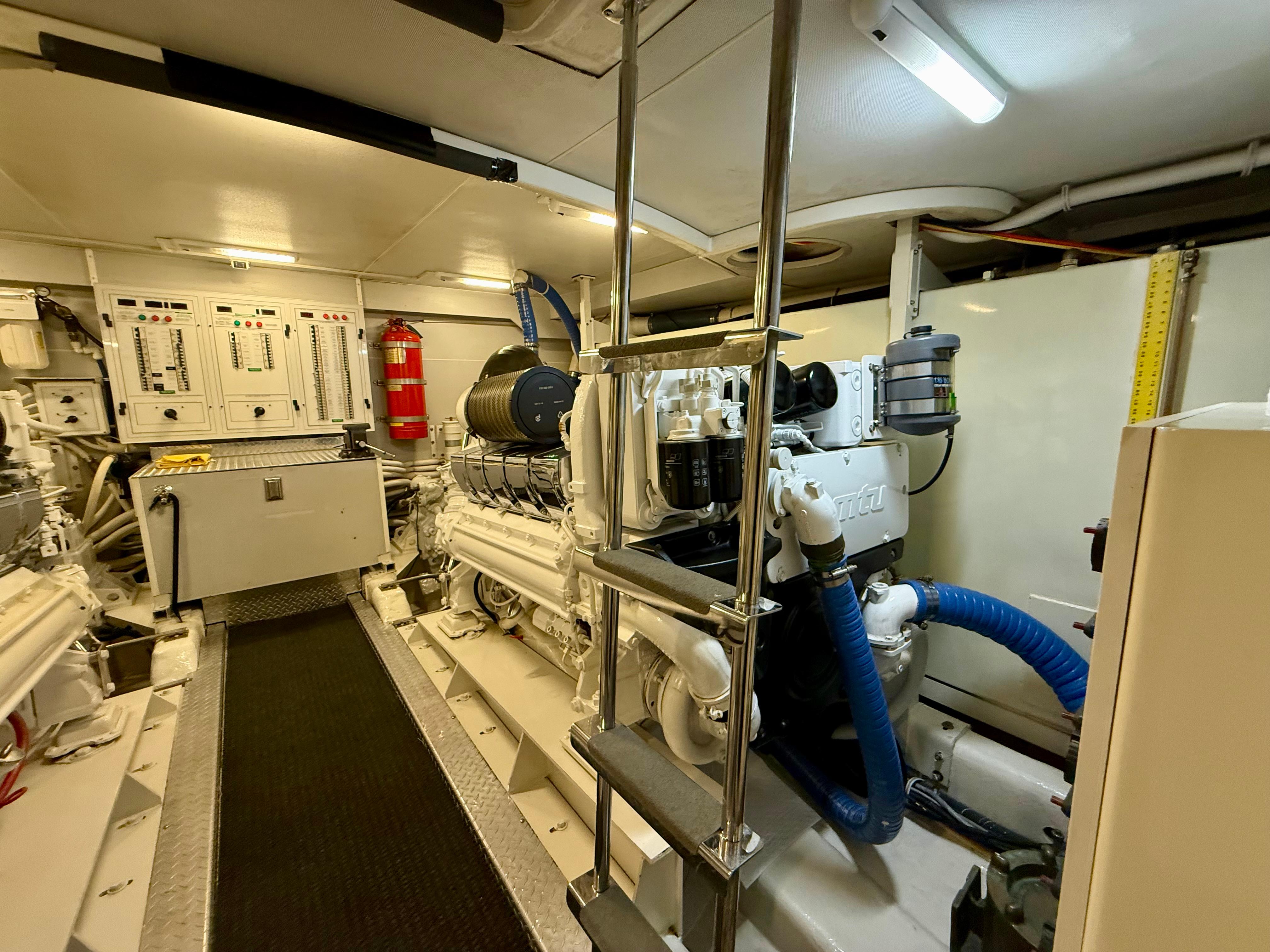 Marquis-65 2005-Tenacity FL-US-Engine room of a 2005 Marquis 65 yacht, featuring machinery and control panels.-9656261 | Thumbnail