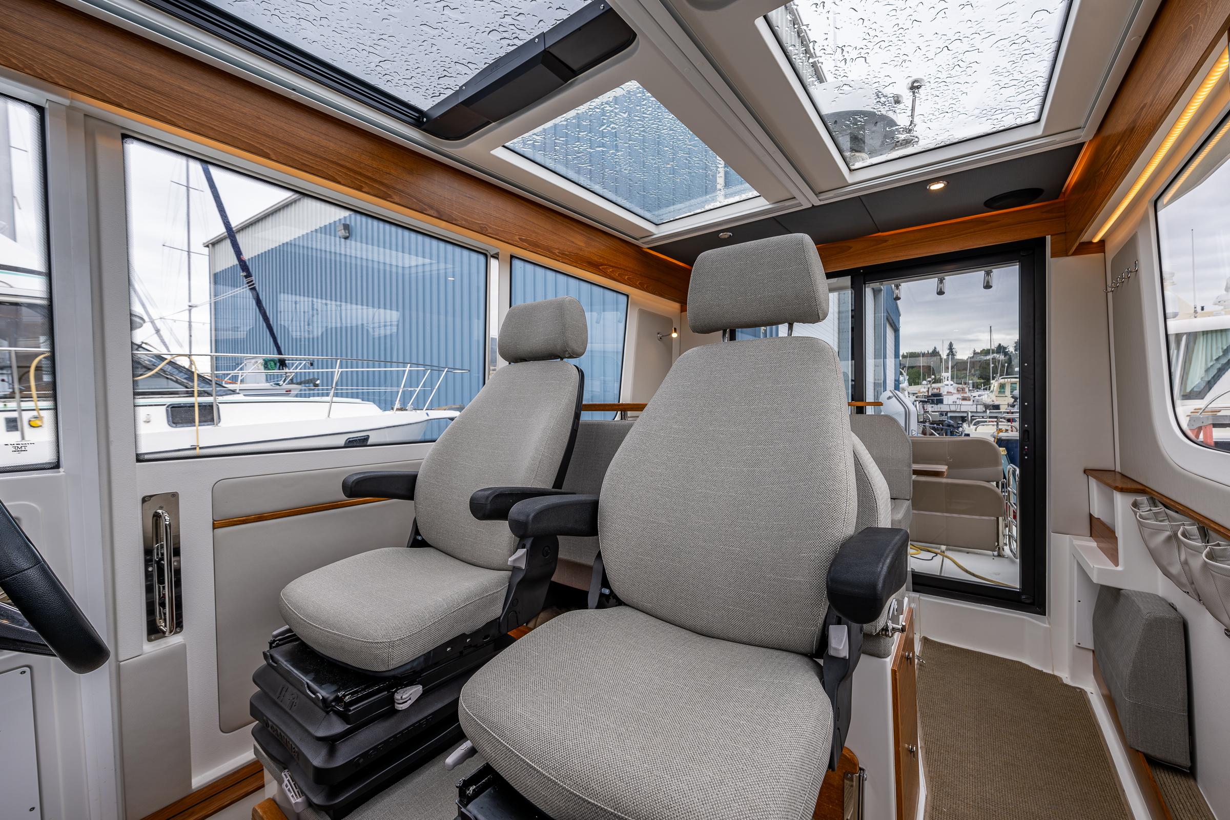 Nimbus-C11 2021-RYLEA ROSE WA-US-Interior of 2021 Nimbus C11 boat with two cushioned seats and panoramic windows.-9586288 | Thumbnail