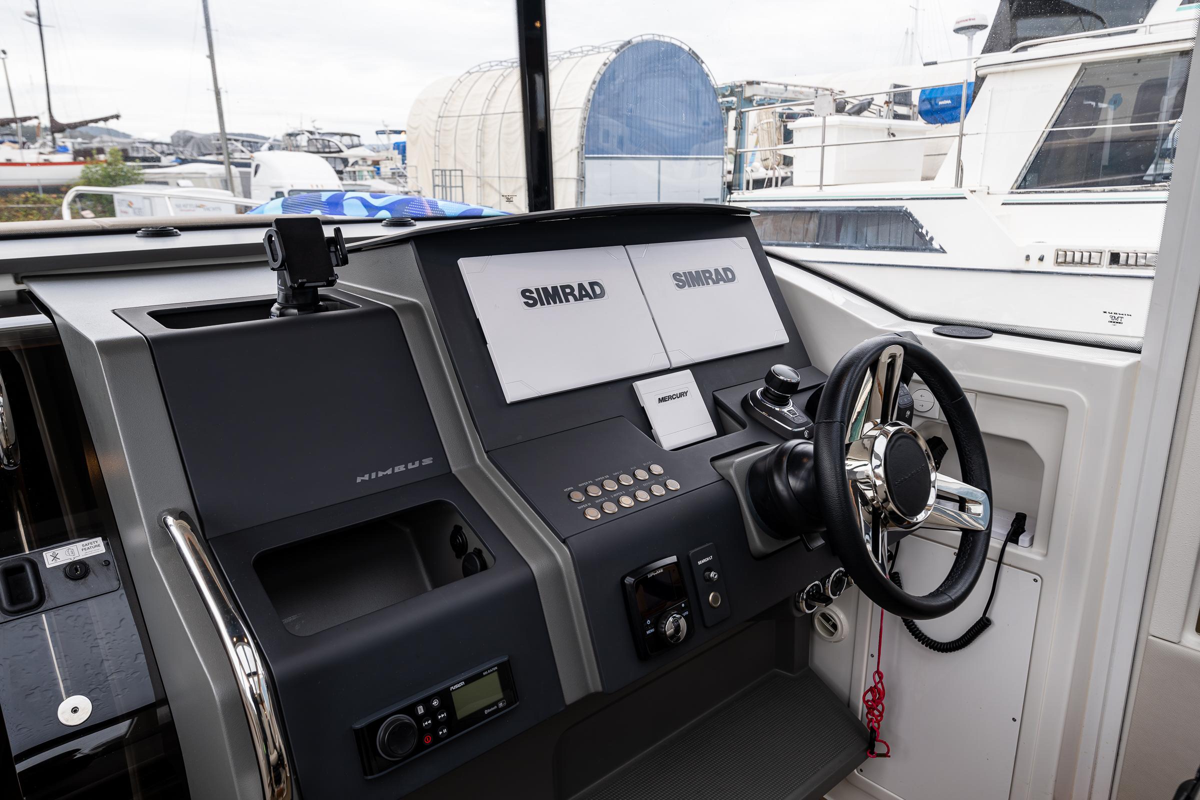 Nimbus-C11 2021-RYLEA ROSE WA-US-Nimbus C11 2021 boat dashboard with Simrad navigation system and steering wheel.-9586288 | Thumbnail