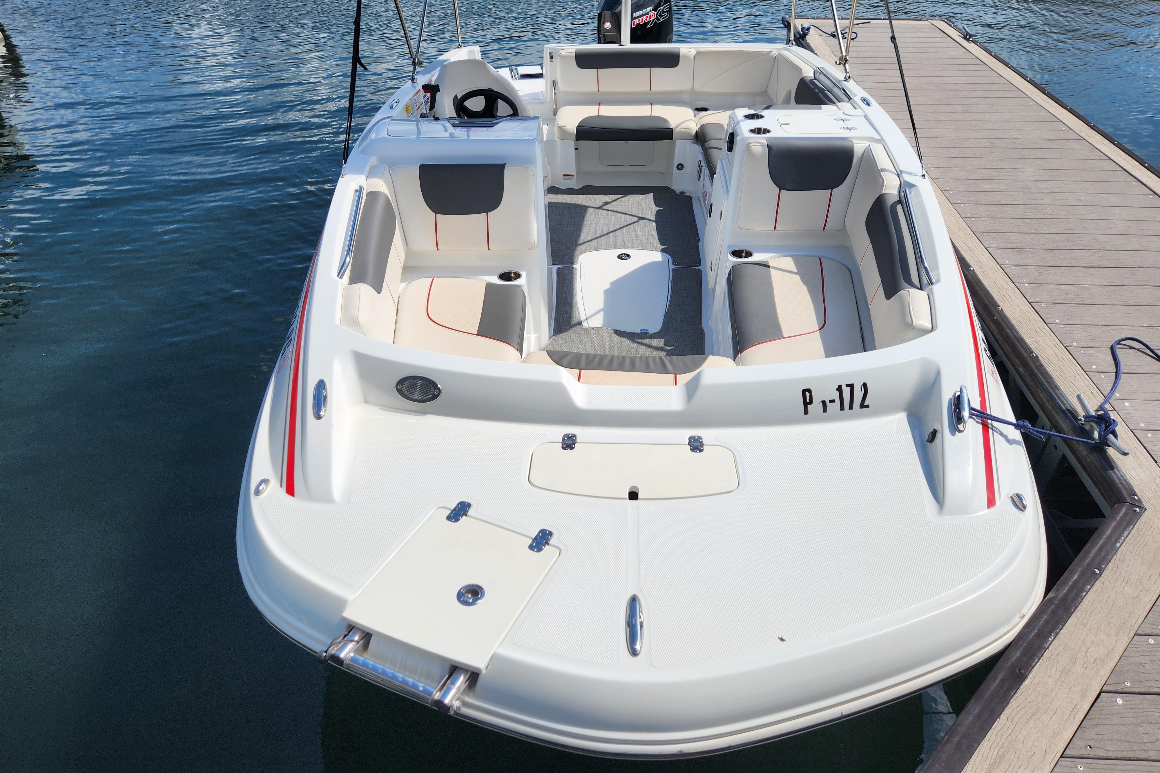 Tahoe 1950 boat, 2021 model, docked on calm water with spacious seating.