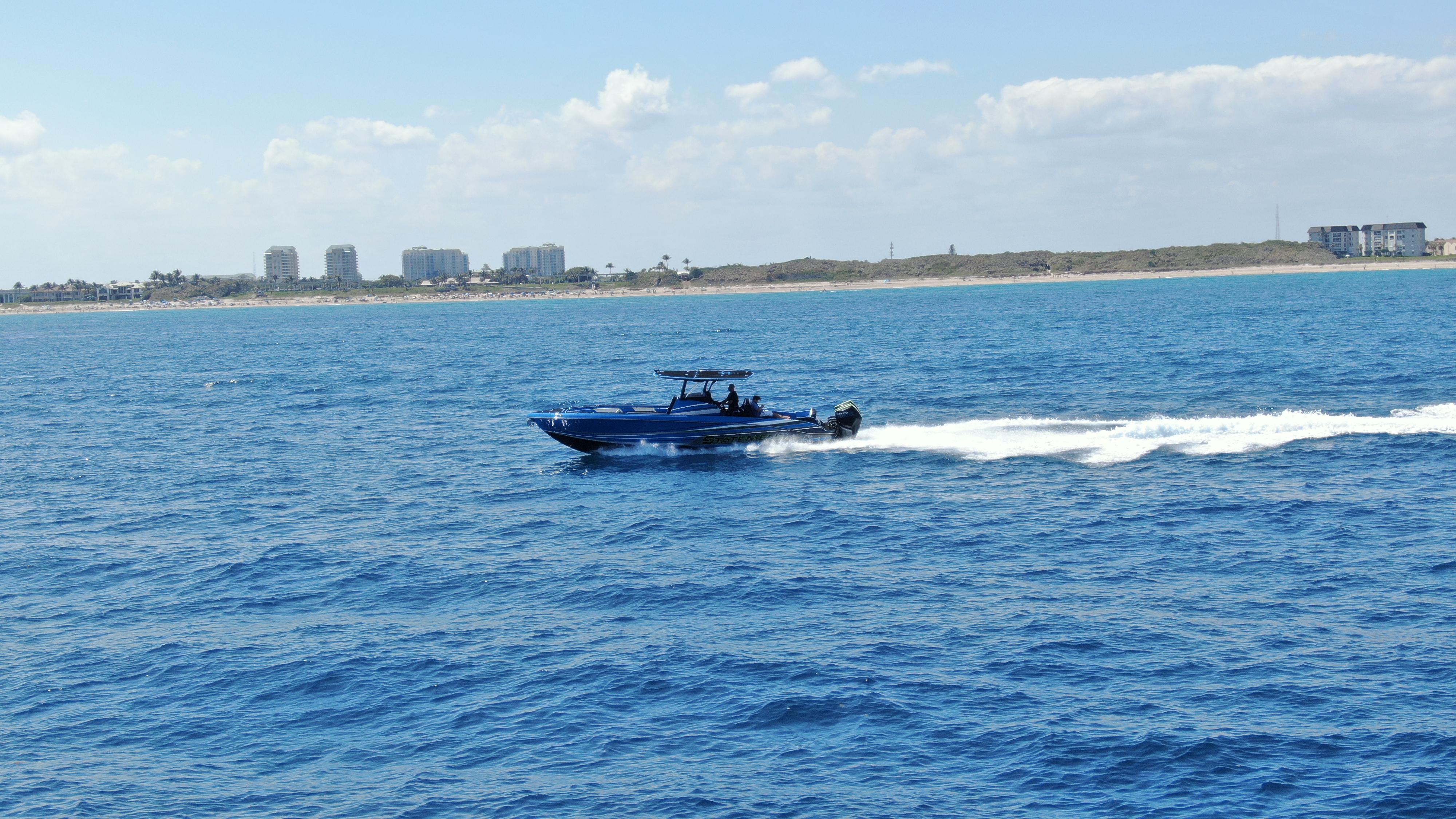 Statement-380 Open 2022-Riptide FL-US-2023 Statement 380 Open boat cruising on blue ocean near coastline.-9716318 | Thumbnail