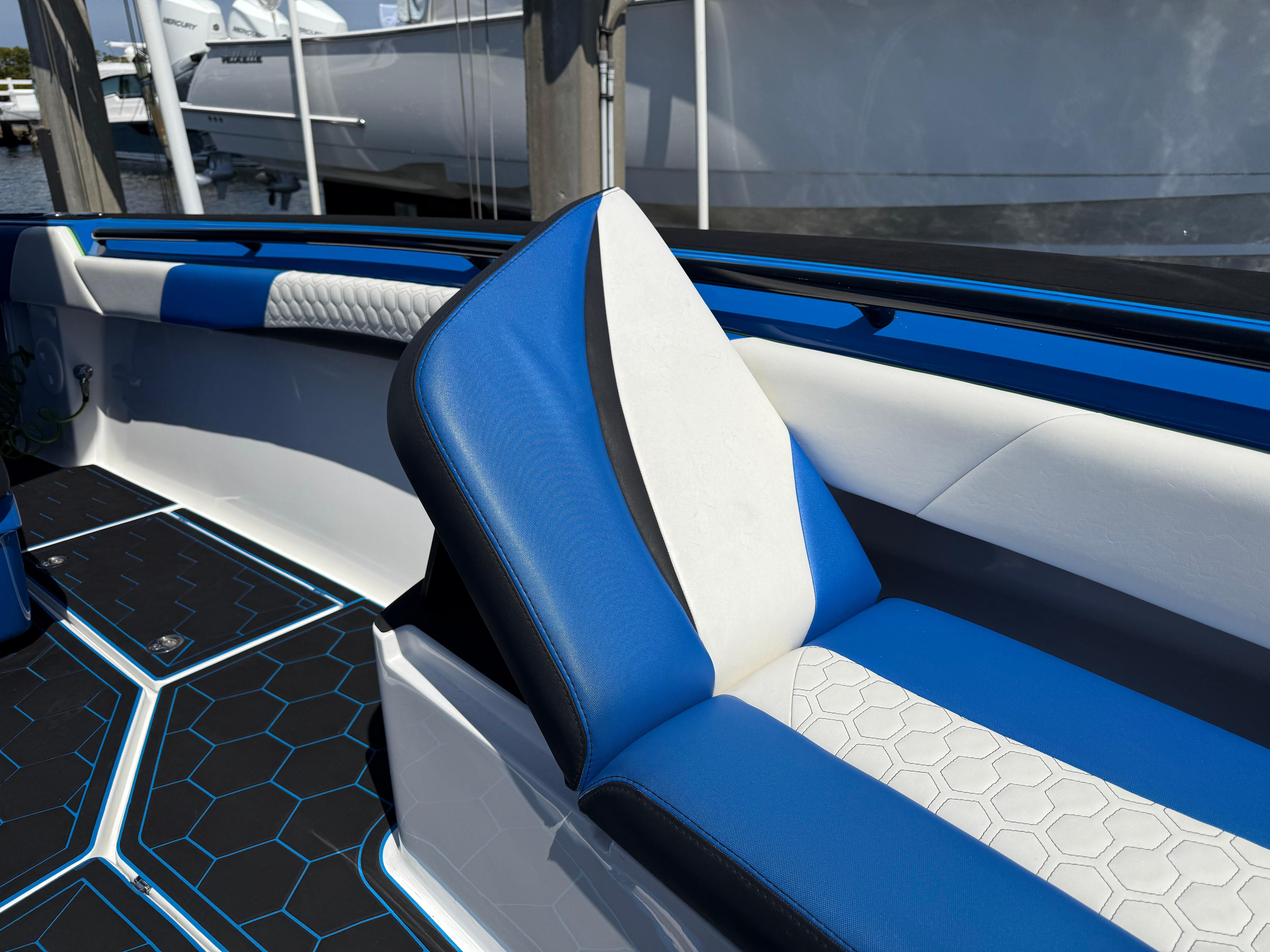 Statement-380 Open 2022-Riptide FL-US-2023 Statement 380 Open boat interior with blue and white seating, hexagonal floor pattern.-9716318 | Thumbnail