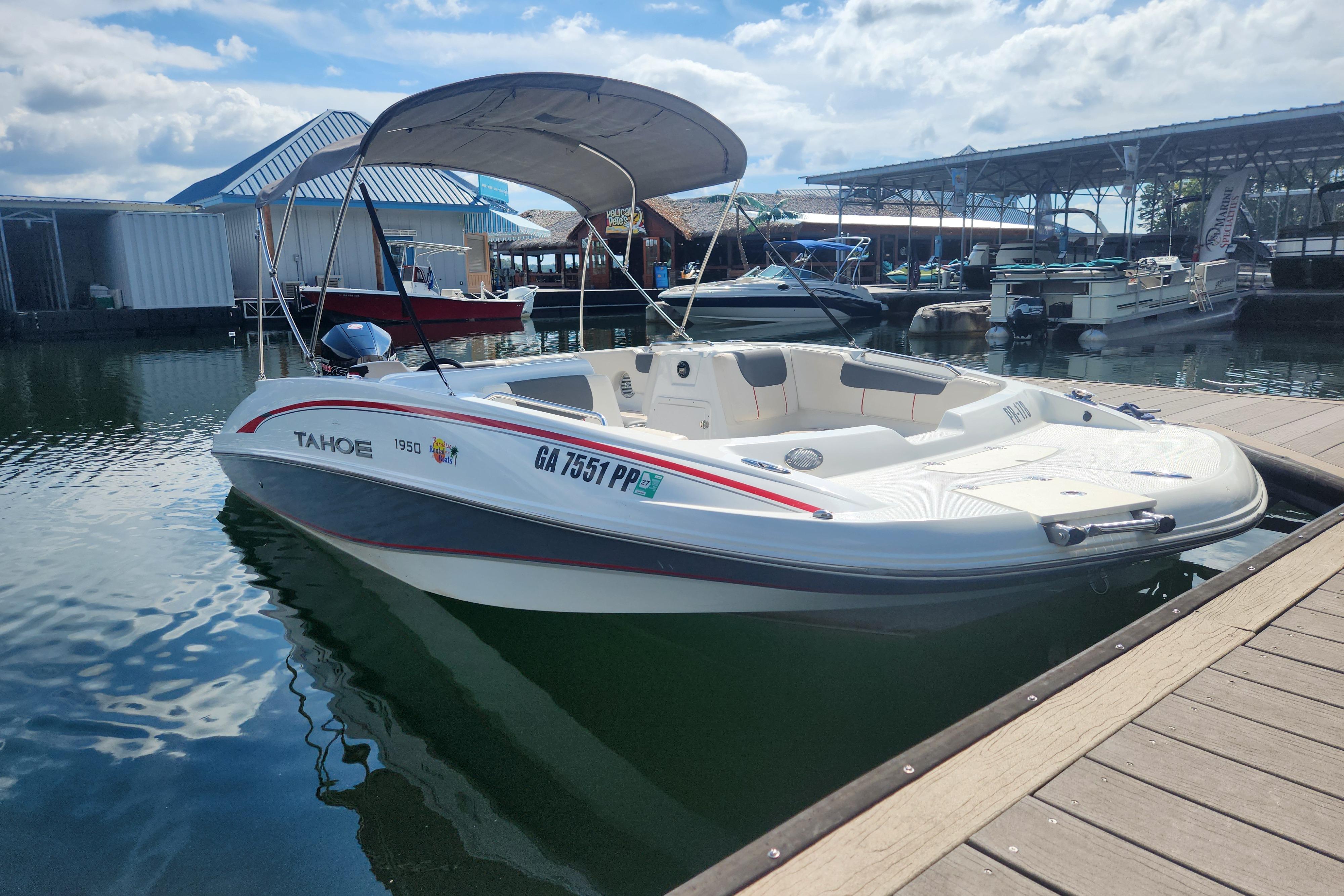 Tahoe 1950 boat, 2021 model, docked at marina under sunny skies.