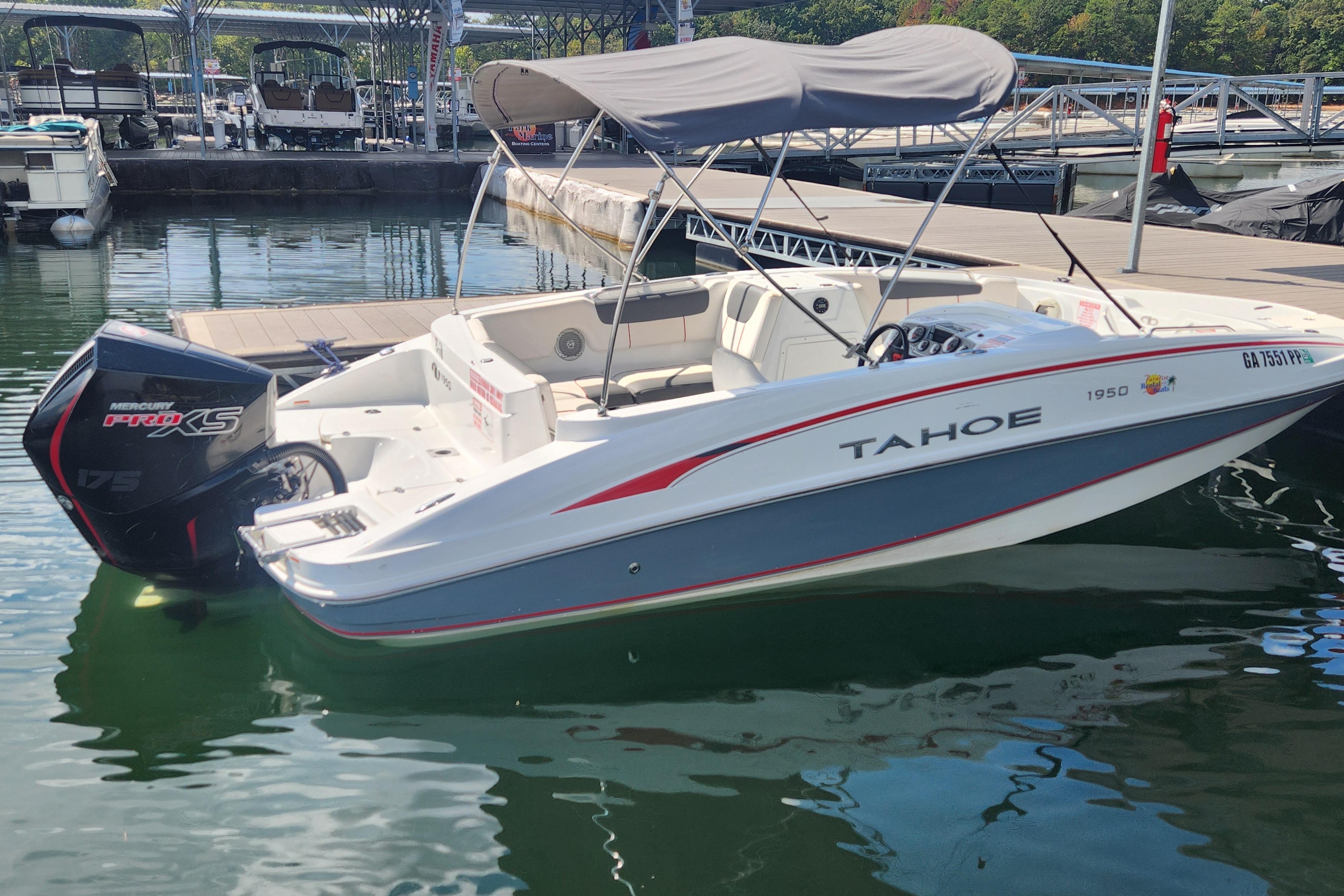 2021 Tahoe 1950 boat docked at marina with Mercury Pro XS engine.