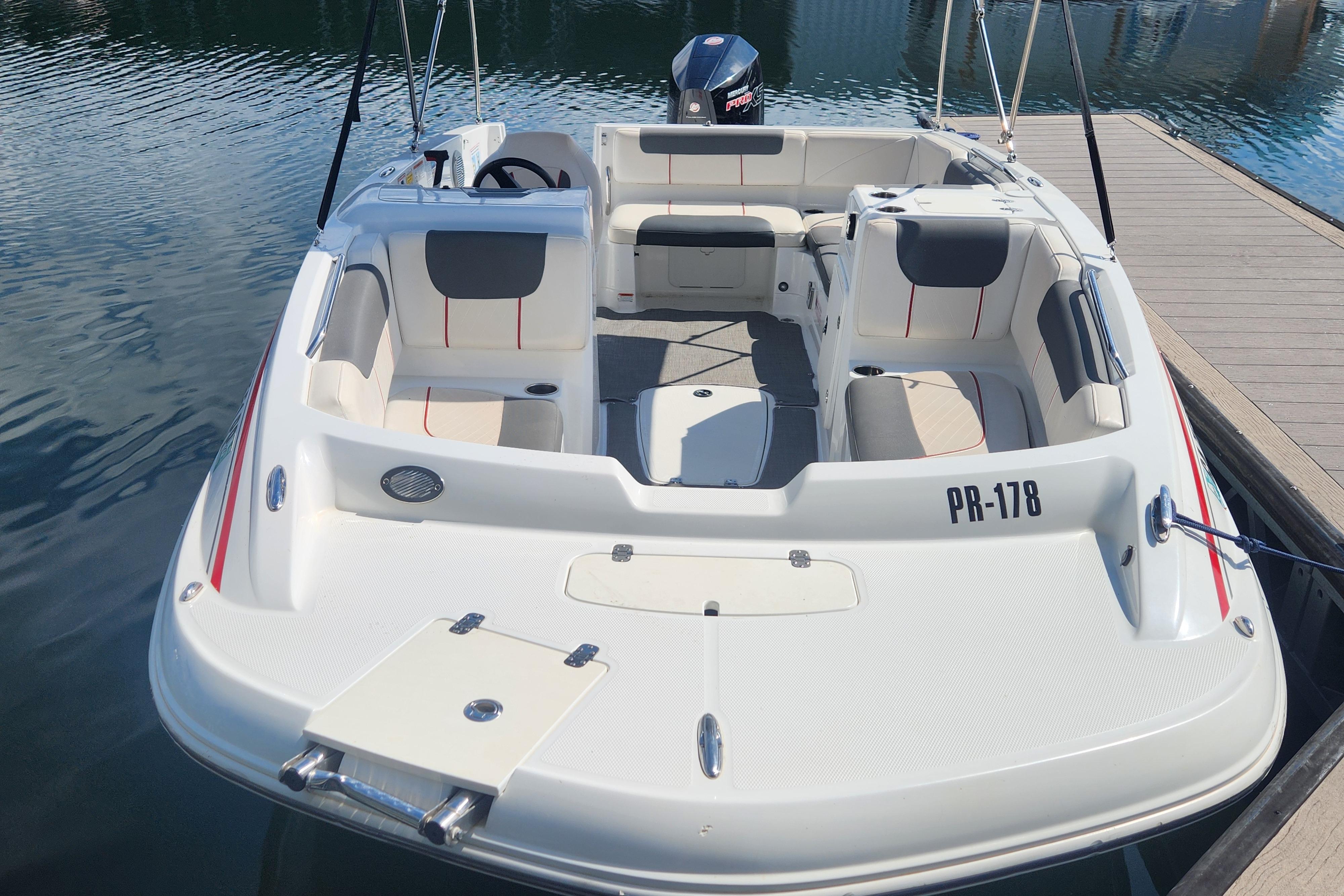 2021 Tahoe 1950 boat docked, featuring spacious seating and sleek design.