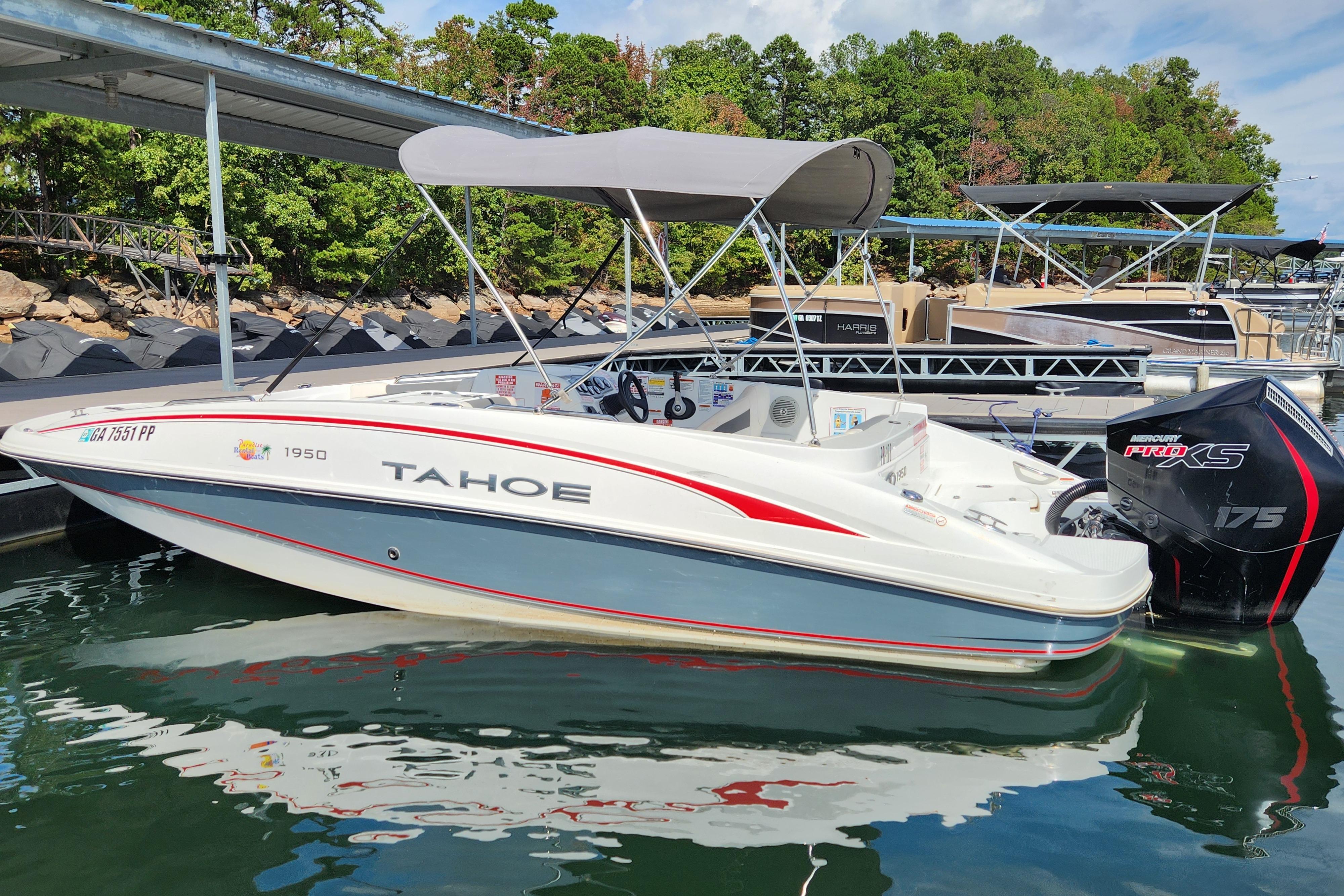 2021 Tahoe 1950 boat docked, featuring a canopy and Mercury Pro XS engine.