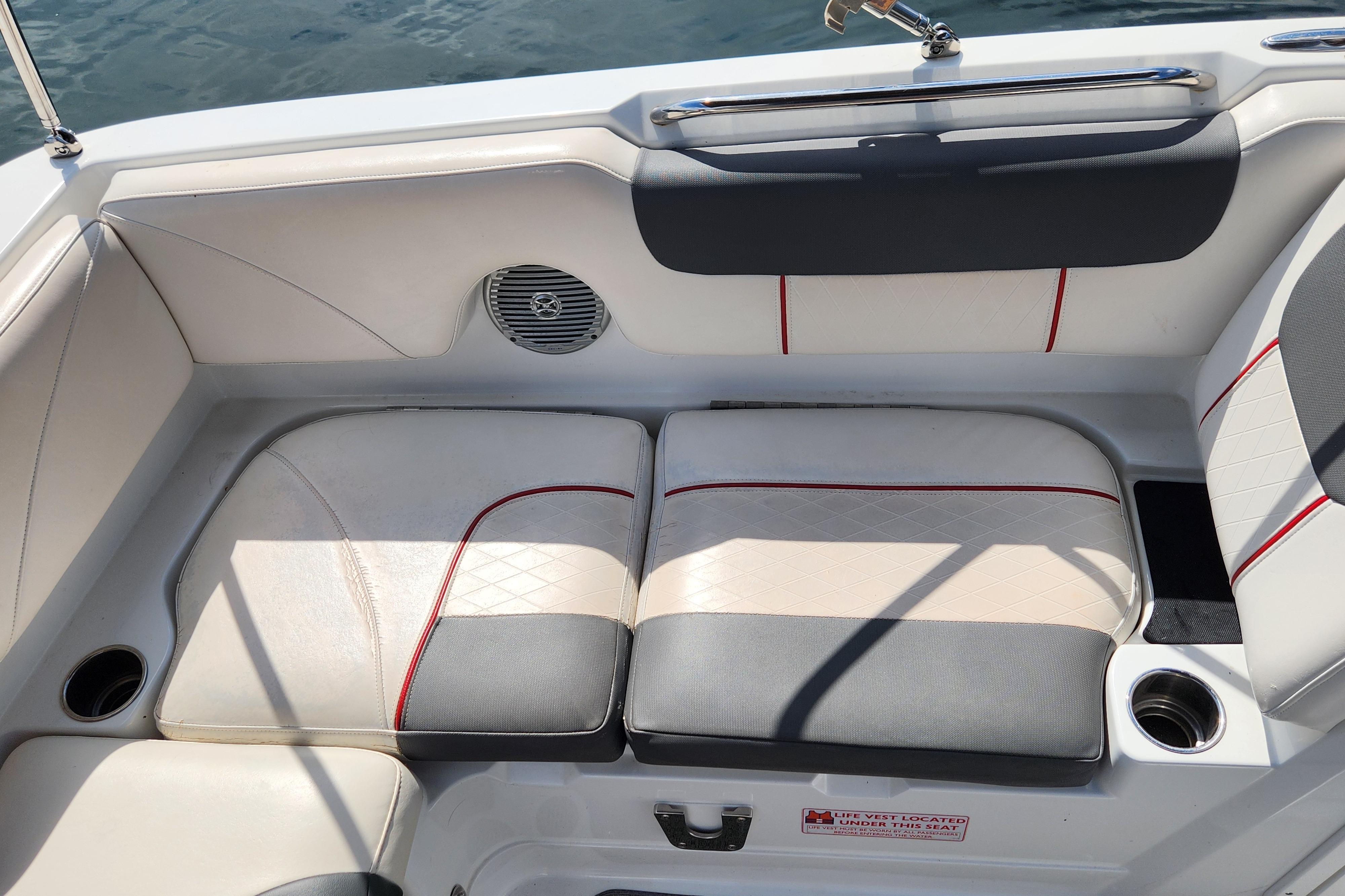 Boat seating area in a 2021 Tahoe 1950, featuring cushioned seats and cup holders.