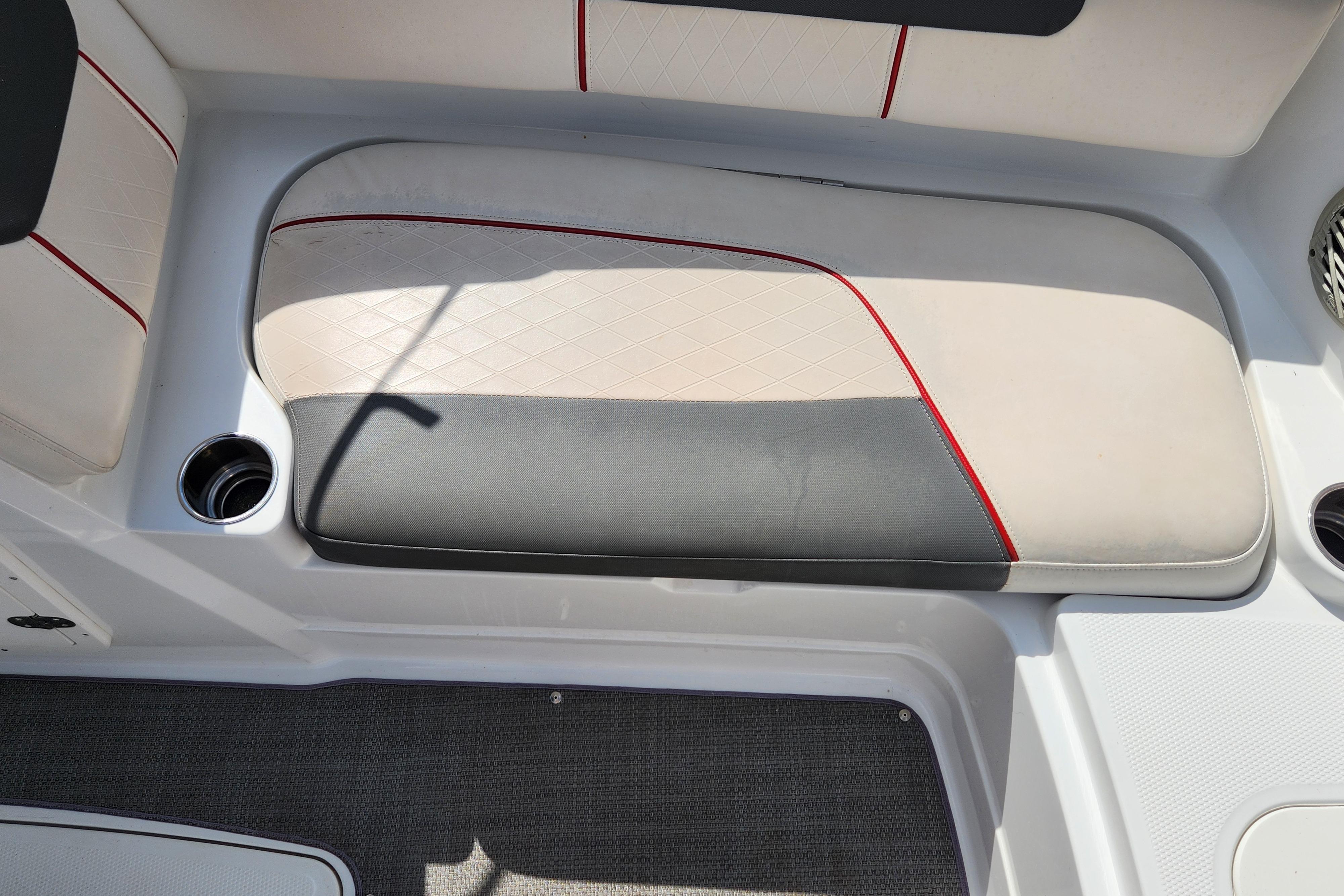 Boat seating area in a 2021 Tahoe 1950, featuring cup holders and stylish upholstery.