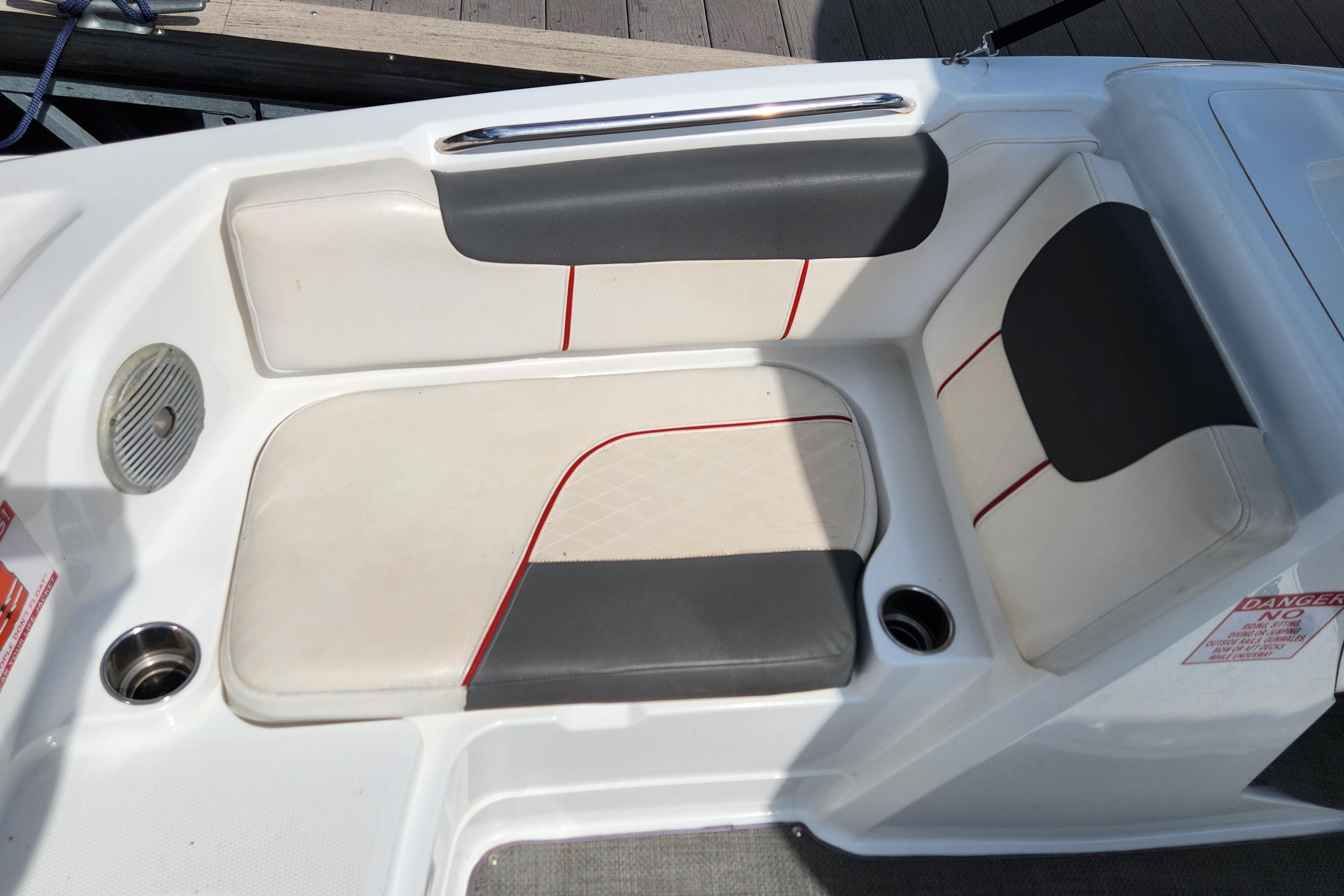 Tahoe 1950 boat seating area, 2021 model, featuring white and gray upholstery with red accents.