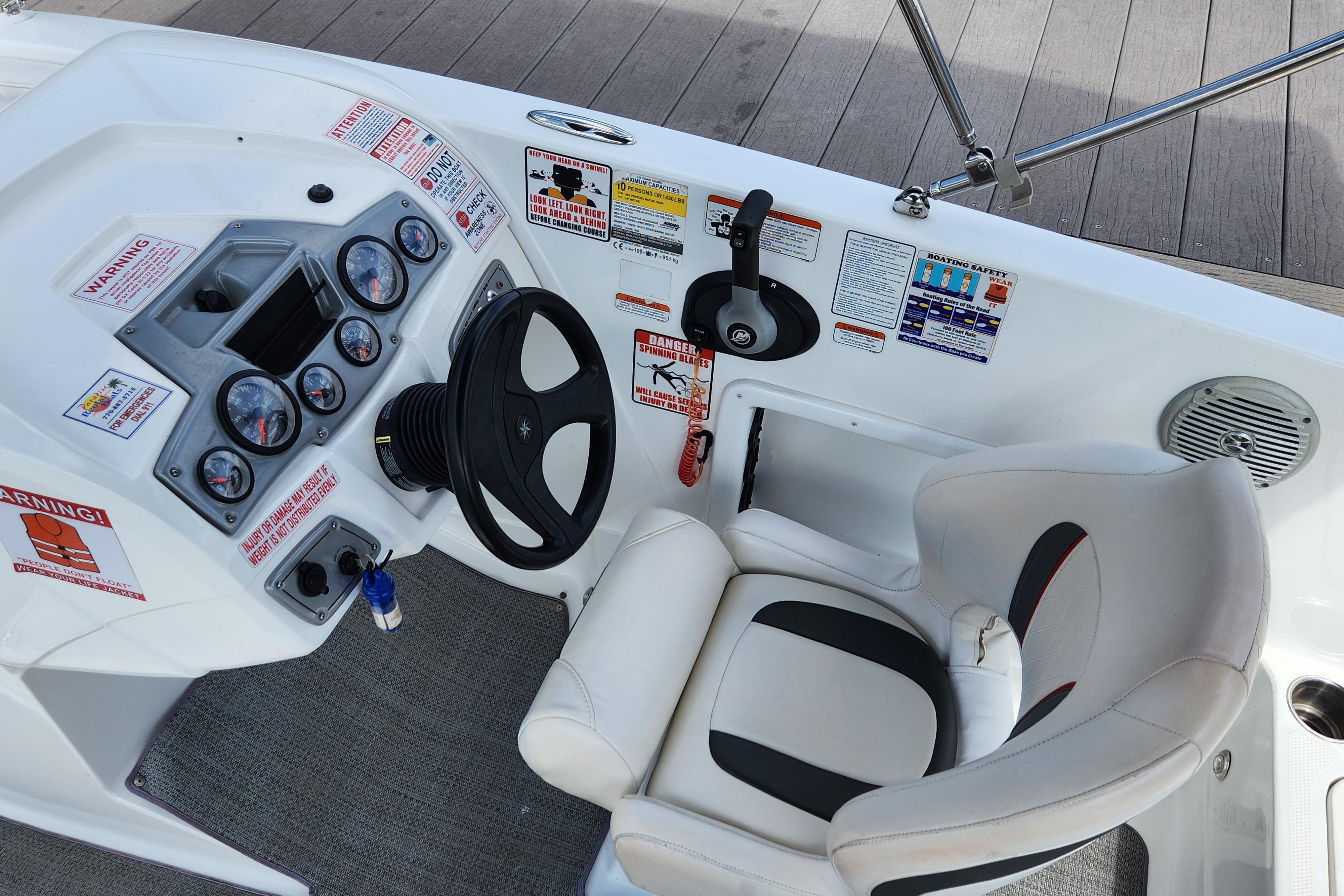 Cockpit of a 2021 Tahoe 1950 boat with steering wheel and control panel.