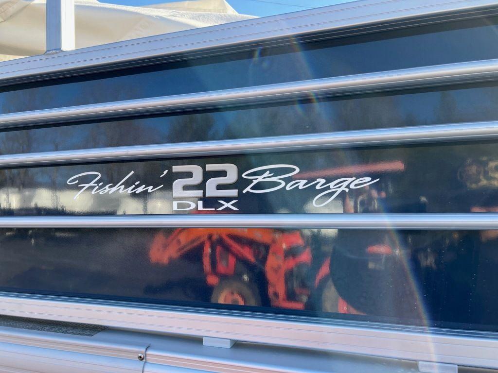 2023 Sun Tracker FISHIN' BARGE® 22 XP3 boat side view with model name.
