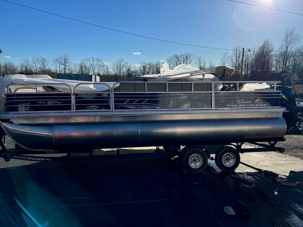 2023 Sun Tracker FISHIN' BARGE® 22 XP3 pontoon boat on a trailer.
